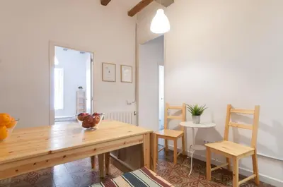 a dining room with a wooden table and chairs at Gopal - Piso 7 pax con wifi y calefacción Gracia Barcelona in Barcelona