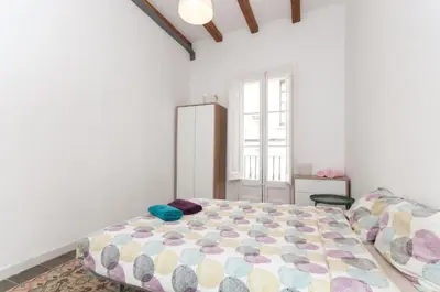 a bedroom with a large bed and a window at Gopal - Piso 7 pax con wifi y calefacción Gracia Barcelona in Barcelona