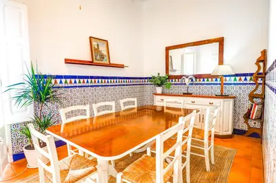 a dining room with a table and a mirror at The Beach House Paradise by Hello Homes Sitges in Sitges