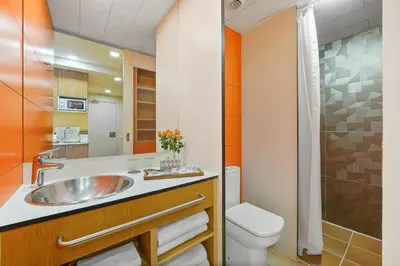 a bathroom with a sink and a toilet at Abarco Apartments in Santa Coloma
