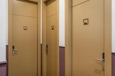 a row of doors in a locker room at BYPILLOW Ramblas in Barcelona