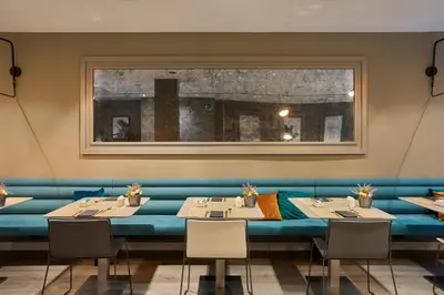 a dining room with two tables and a window at Catalonia Gran Via BCN in Barcelona
