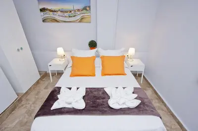 a bedroom with a bed with orange and white pillows at Barcelona City Seven Hostal in Barcelona