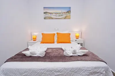 a bedroom with a bed with two white flowers on it at Barcelona City Seven Hostal in Barcelona