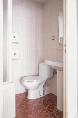 a bathroom with a toilet and a sink at Barcelona City Street Hostal in Barcelona