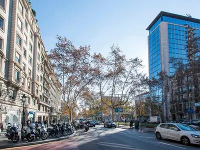 a group of motorcycles parked on a city street at Fewdays Barcelona Apartments in Barcelona