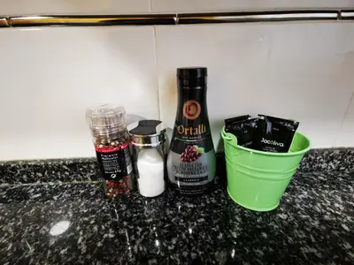 a counter top with two bottles of spices and a container at Elsi's place in Premiá de Mar