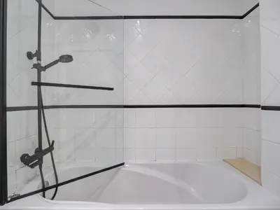 a shower in a bathroom with a tub at White Center Apartment by Hello Homes Sitges in Sitges