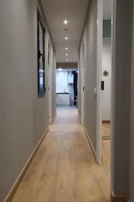 an empty hallway with a long hallway with wood floors at Sagrada Familia Xamfrà in Barcelona