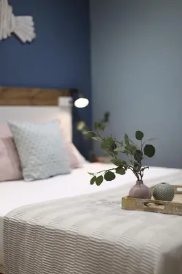 a vase with a plant on top of a bed at Sagrada Familia Xamfrà in Barcelona