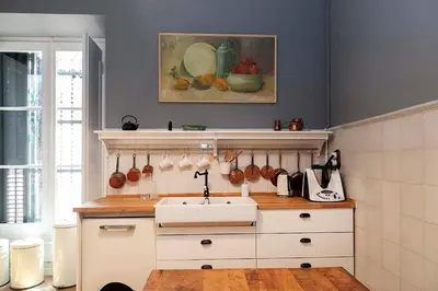 a kitchen with a sink and a painting on the wall at A historic XVI century beach home near Barcelona in Caldes d'Estrac