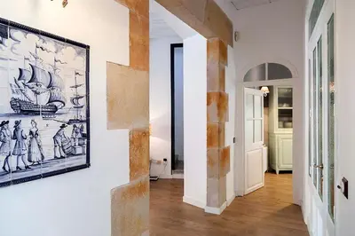 a hallway of a home with a painting on the wall at A historic XVI century beach home near Barcelona in Caldes d'Estrac