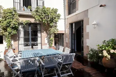 a blue table and chairs on a patio at A historic XVI century beach home near Barcelona in Caldes d'Estrac