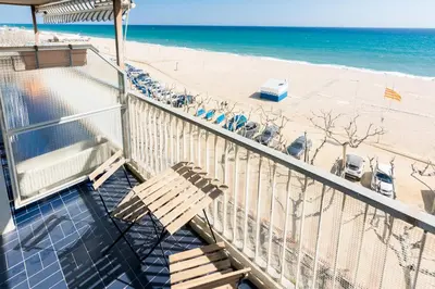 a balcony with a bench next to the beach at HomeHolidaysRentals Etoile in Calella