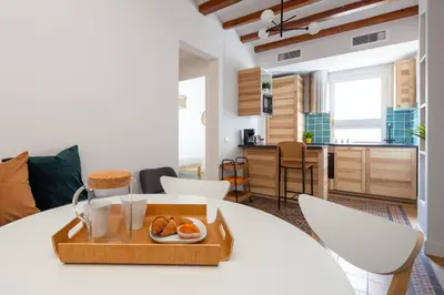 a room with a table with a tray of food on it at Casa Cosi - Francoli 1 in Barcelona