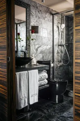 a bathroom with a black toilet and a sink at Aparthotel Arai 4* Superior in Barcelona