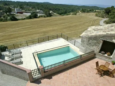 a swimming pool on top of a house with a field at Mansion in Maians with Private Pool in Castellfullit del Boix