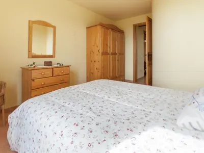 a bedroom with a bed and a dresser and a mirror at Cottage in Maians with Sea View & Pool in Castellfullit del Boix