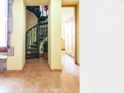 a hallway with a staircase in a house at 17th century farmhouse in Bages, near Montserrat in Castellfullit del Boix