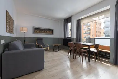 a living room with a couch and a table and chairs at Enjoybcn Patio de Gala in Barcelona