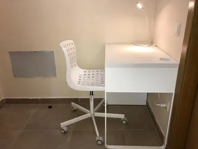 a white desk with a chair next to a table at Urban Manresa-City center apartment with balcony in Manresa