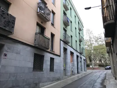 an empty street in a city with buildings at Urban Manresa-City center apartment with balcony in Manresa