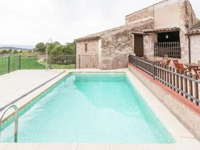 a swimming pool in front of a house at Cottage in Maians with Pool and Garden in Castellfullit del Boix