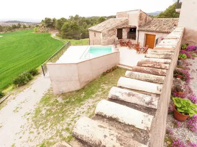 an external view of a house with a swimming pool at Cottage in Maians with Pool and Garden in Castellfullit del Boix