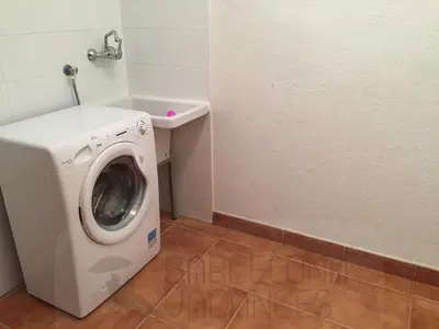 a washing machine in a bathroom with a sink at BarcelonaVacances-Villa Lucia in San Pol de Mar