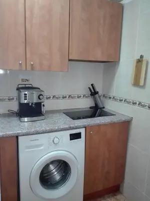 a kitchen with a washing machine and a sink at UN ESPACIO DONDE CREAR GRANDES RECUERDOS in Calella