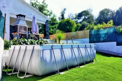 a large white planter in the yard of a house at Ca la Nena Morena - Refugio cálido con chimenea y vistas al Montseny in Vallgorguina