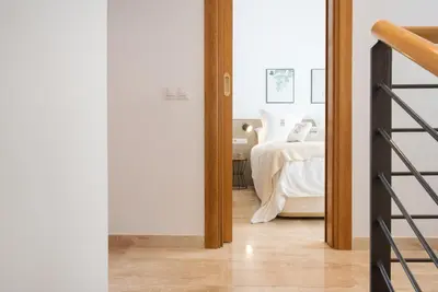 a view of a bedroom with a bed and a ladder at Petit Luxe Ègara in Terrassa