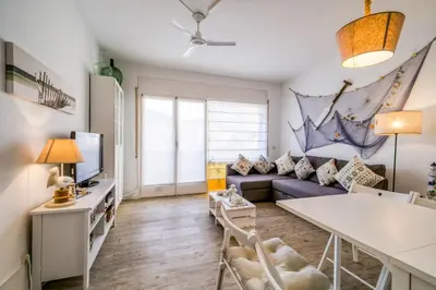 a living room with a couch and a table at Vivalidays ilaria - Calella in Calella