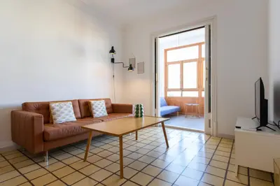 a living room with a couch and a table at EG42B - Piso modernista 6 pax con WIFI en centro Barcelona in Barcelona