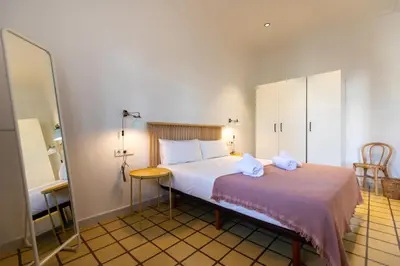 a bedroom with a bed with two towels on it at EG42B - Piso modernista 6 pax con WIFI en centro Barcelona in Barcelona