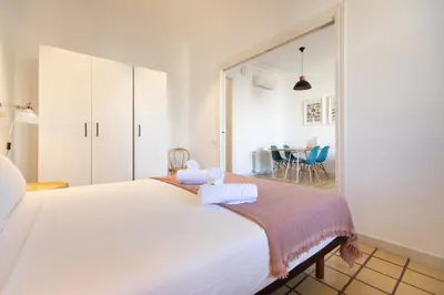 a bedroom with a large white bed with towels on it at EG42B - Piso modernista 6 pax con WIFI en centro Barcelona in Barcelona