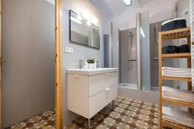 a bathroom with a sink and a shower at b32-Sunny and Modernist apartment for groups in center in Barcelona
