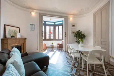 a living room with a couch and a table at b21-Apartamento Modernista para Grupos in Barcelona