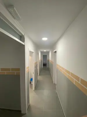 a hallway of a bathroom with stalls in a building at Hostel Penedes in Vilafranca del Penedès