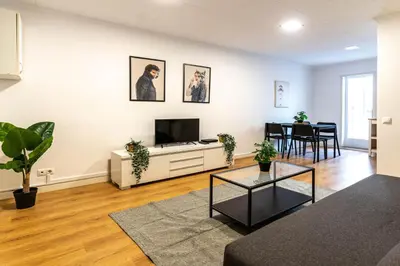 a living room with a television and a table at Magnifico apartamento camp nou in Barcelona