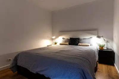 a bedroom with a large bed with two lamps at Magnifico apartamento camp nou in Barcelona