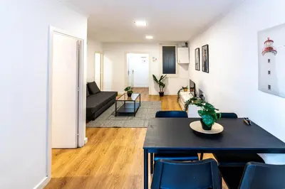 a living room and dining room with a table and chairs at Magnifico apartamento camp nou in Barcelona