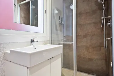 a bathroom with a sink and a shower at Stay U-nique Apartments Eixample Center in Barcelona
