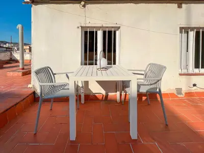a white table and two chairs on a patio at Stay U-nique Apartments Torrent in Barcelona