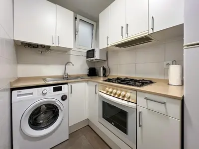 a kitchen with a washing machine and a sink at Stay U-nique Apartments Begur in Barcelona