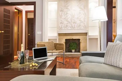 a living room with a laptop on a coffee table at Stay U-nique Apartments Calvet in Barcelona