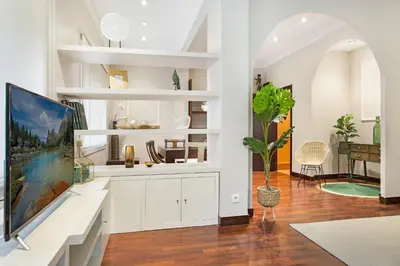 a living room with white cabinets and a tv at Stay U-nique Apartments Calvet in Barcelona