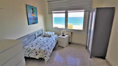 a bedroom with a bed and a view of the beach at MARILU SEAVIEW & BEACH - apartment in Masnou