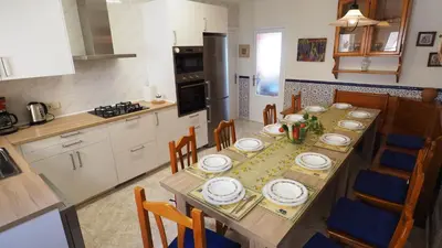 a kitchen with a table with plates on it at MARILU SEAVIEW & BEACH - apartment in Masnou