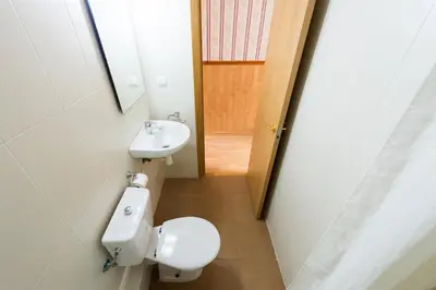 a bathroom with a toilet and a sink at Pensión Villanueva in Barcelona
